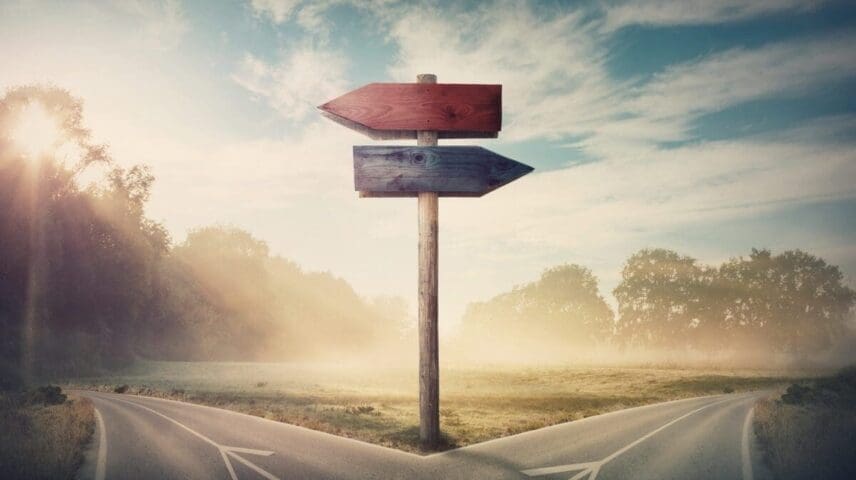 Surreal landscape with a split road and signpost arrows showing