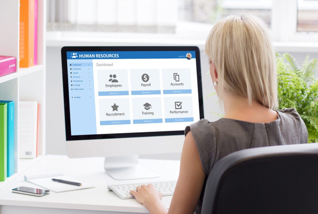 Woman working with human resources software at work