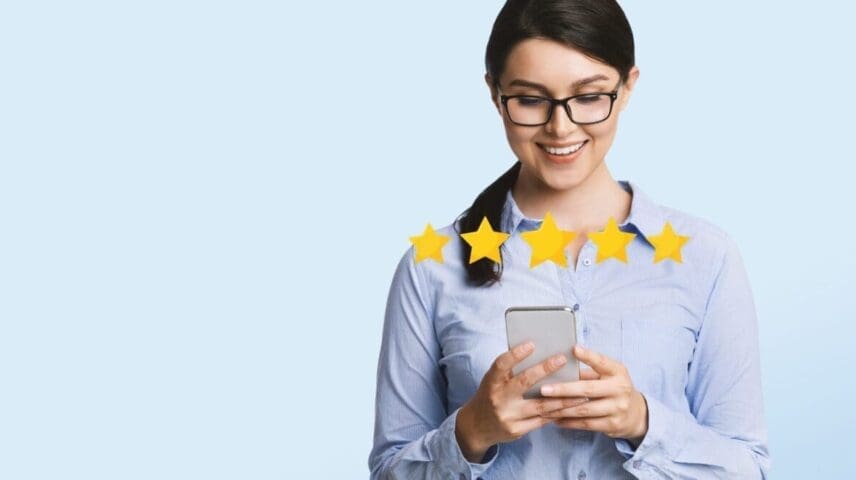 Business App Rating. Happy Millennial Businesswoman Evaluating Mobile Application On Smartphone With Five Stars, Light Studio Background, Panorama