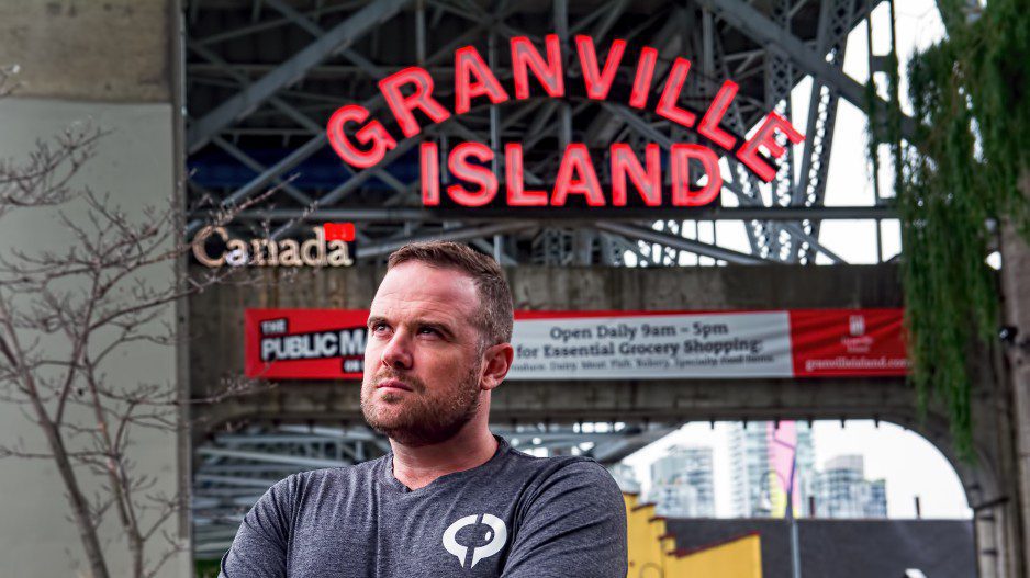 Olive CEO Chris Heard in front of Granville Island sign