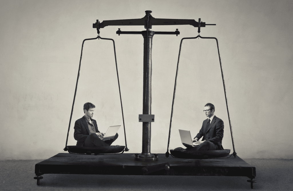 Two business men sit on each side of a scale to depict the idea of Building vs. Buying Enterprise Software and the importance of this Decision
