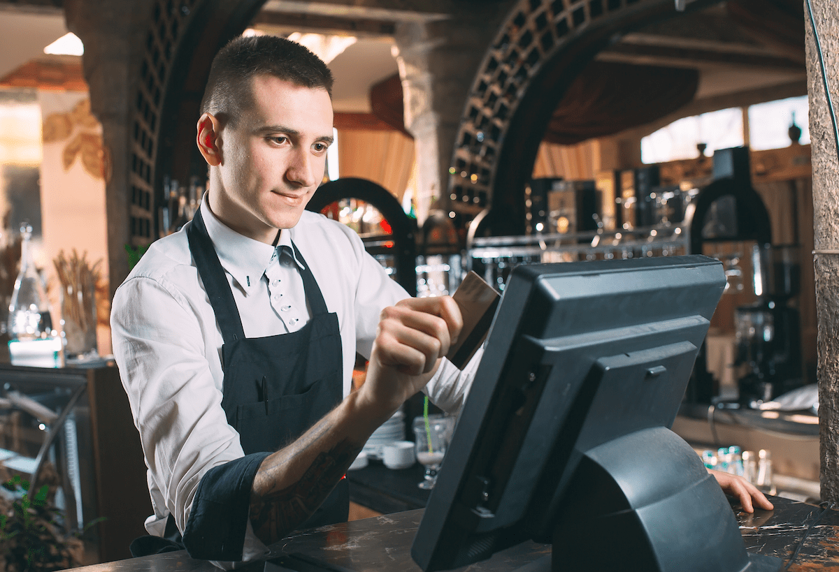 Waiter using POS System in Restaurant - How to Source the Best POS for Your Business